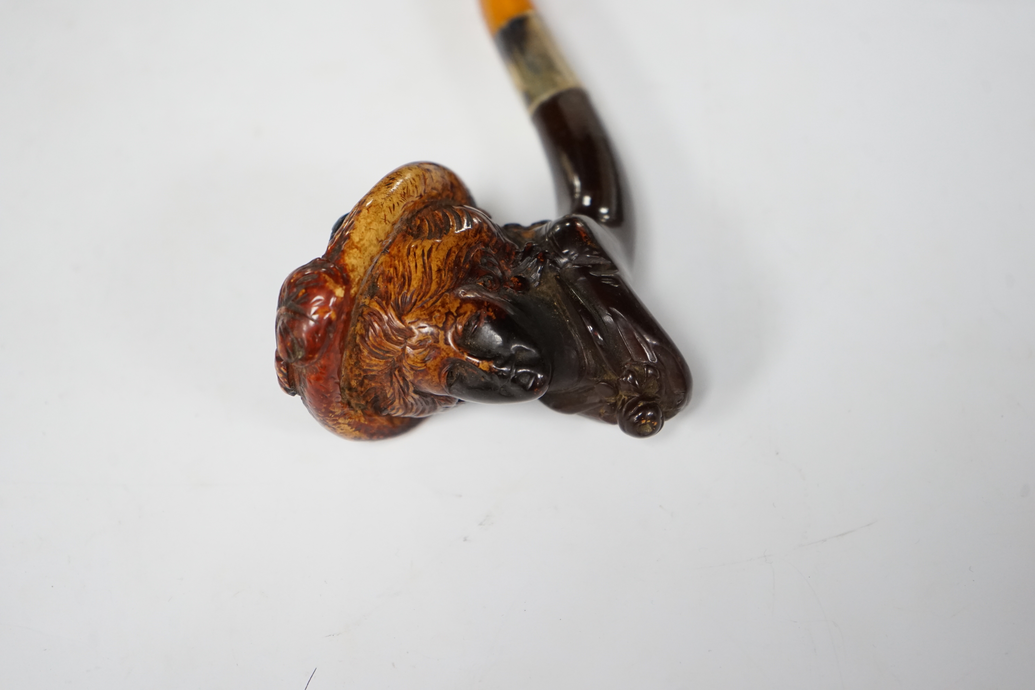 A carved Meerschaum portrait pipe of ‘Mrs Davenport’, late 19th century (see internal note) after a Gainsborough portrait of the lady, with metal mount and amber mouthpiece, 14.5 cm long